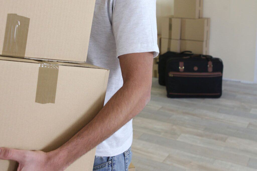 A man carrying a cardboard boxes during relocation