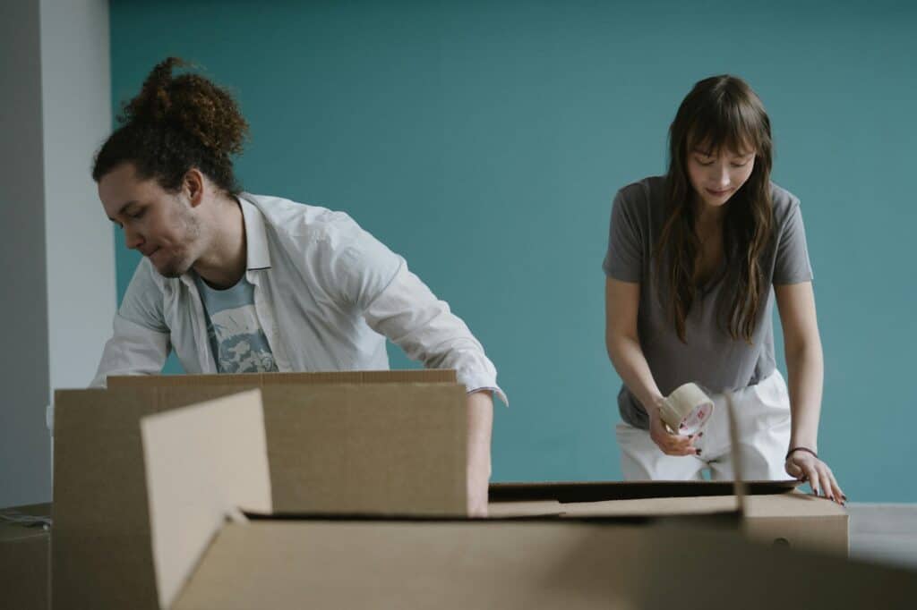 A couple is busy packing for their house move