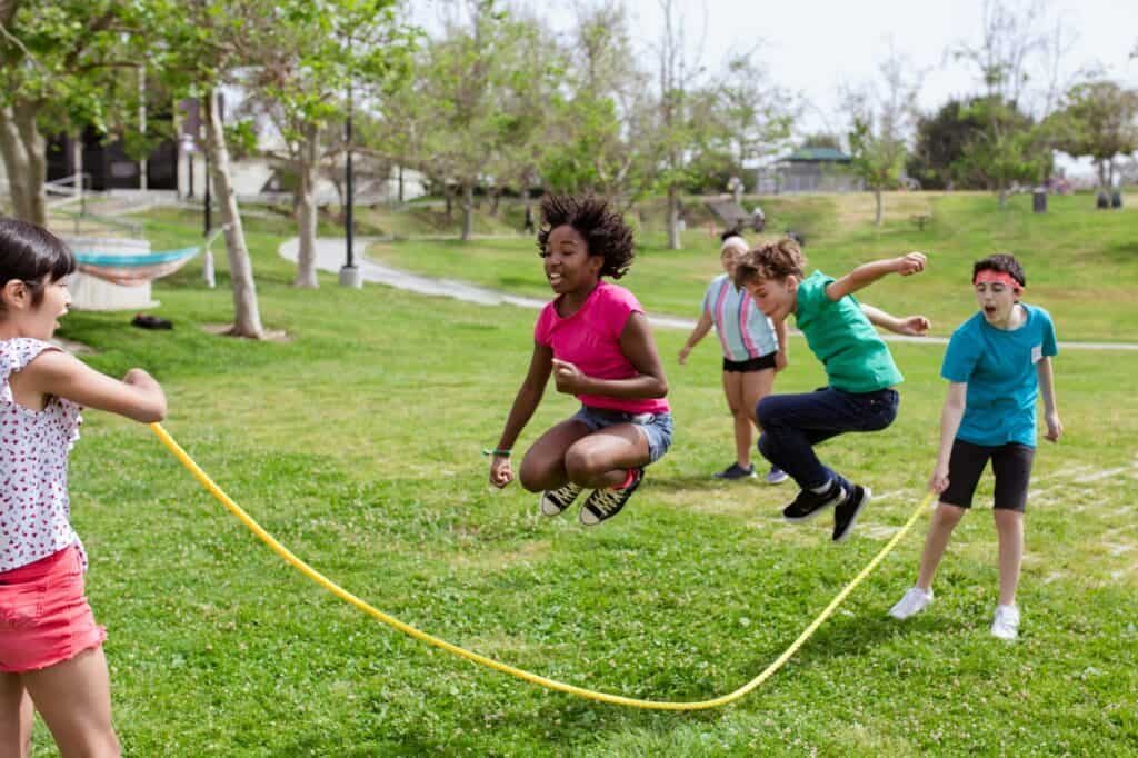 Children playing in a park in the concept of 'best parks and green spaces in Ilford'.