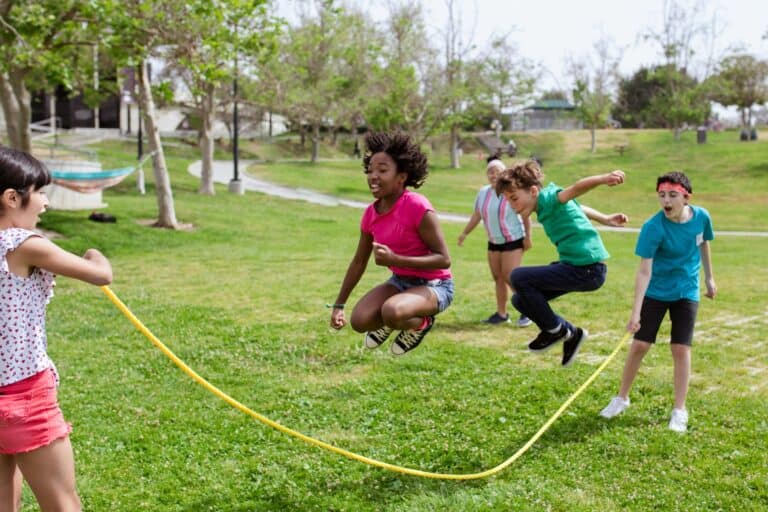 Children playing in a park in the concept of 'best parks and green spaces in Ilford'.