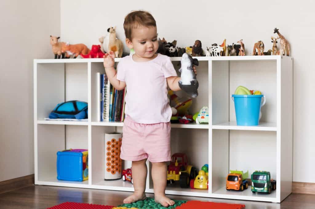 A cute baby playing with toys after settling into their new home