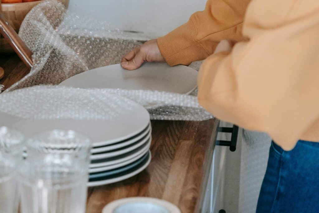 Cropped image of plates being packed for the move